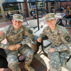 Two students, who are active members of the military, sitting in front of the Shafer Court Dining Center