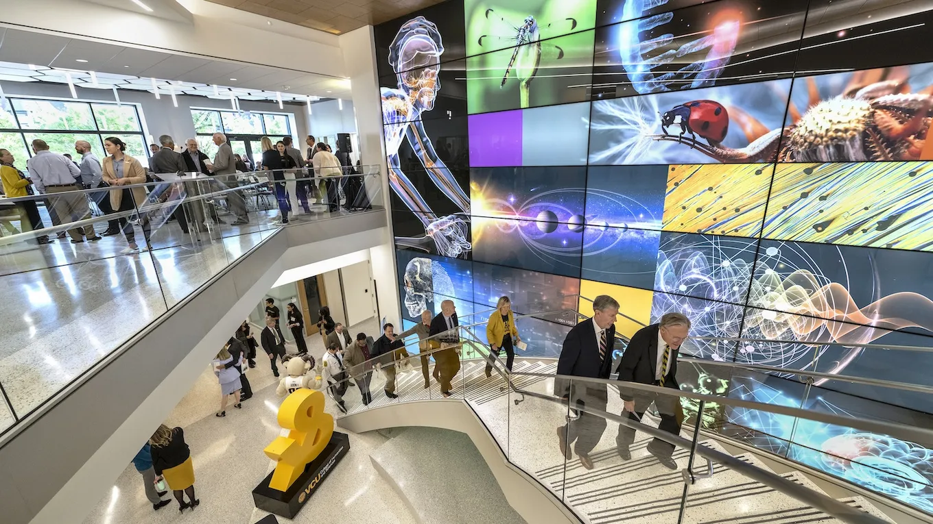 The building’s two-story atrium features backlit glass panels of scientific images.