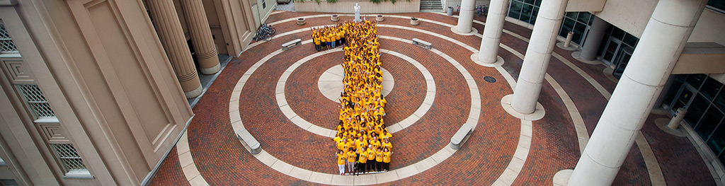 Staff members of the VCU Medical Center stand together to form a giant No. 1