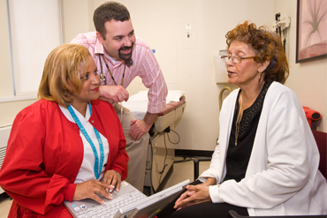 Doctor and nurse talking with a patient