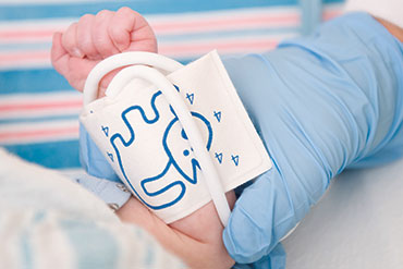 Doctor's hand holding an infants arm