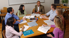 People at meeting sitting around a table