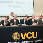 President Michael Rao, Ph.D., with Community Memorial Healthcenter leaders signing agreement