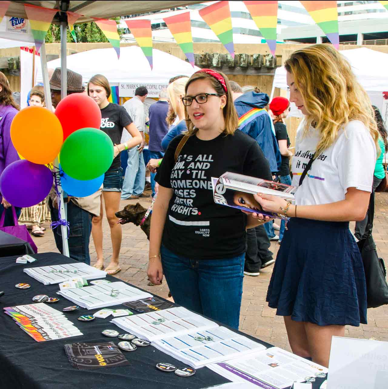 Two students getting information about Equity VCU at a student organization fair.