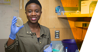 Abigail Oyelayo in a laboratory holding lab containers