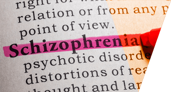 Close-up of a printed page with the word schizophrenia highlighted in pink
