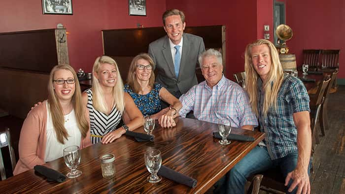 John Cummings and family posing with Alan Dow, M.D.