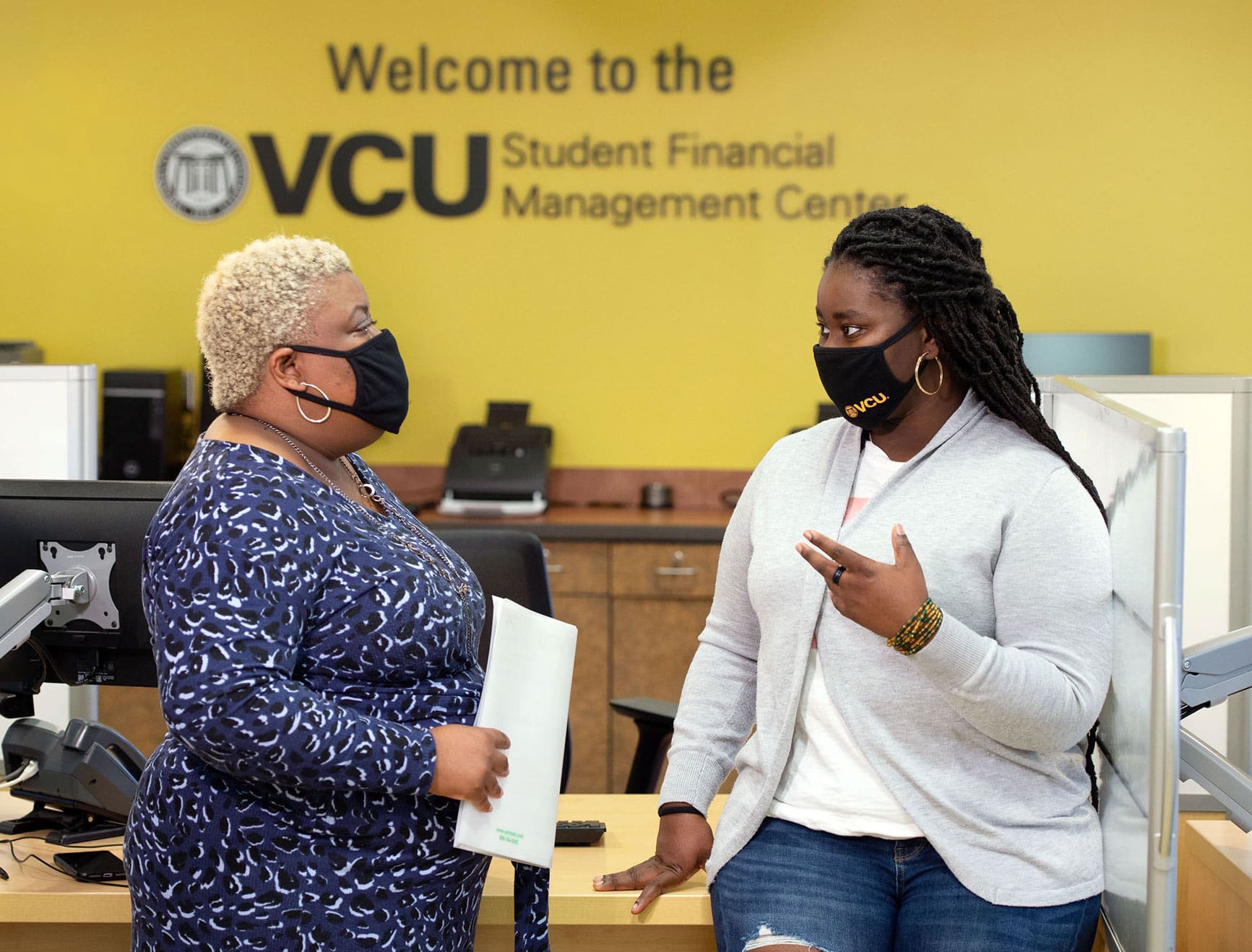 Margaret Boateng talking with a counselor from Financial Services.